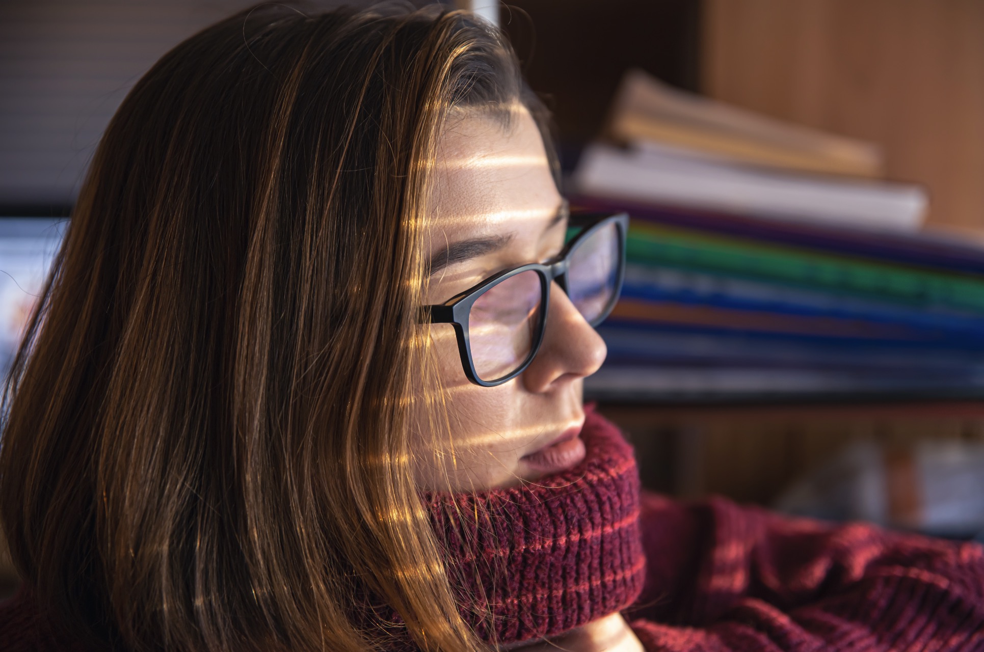 Woman sitting in the dark with turtleneck sweater- Adult ADHD